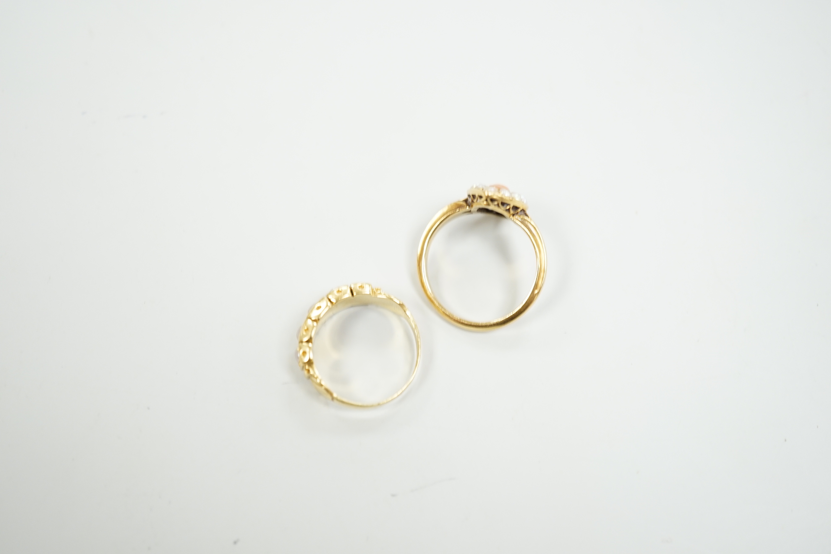 A late Victorian yellow metal, split pearl and coral set marquise shaped ring, size L and a similar yellow metal and split pearl set half hoop ring, gross weight 8 grams.